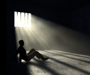 37597340 - prisoner in dark room with light beams